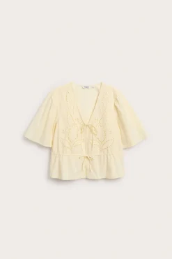 Blus i bomullspoplin med broderi och knytband