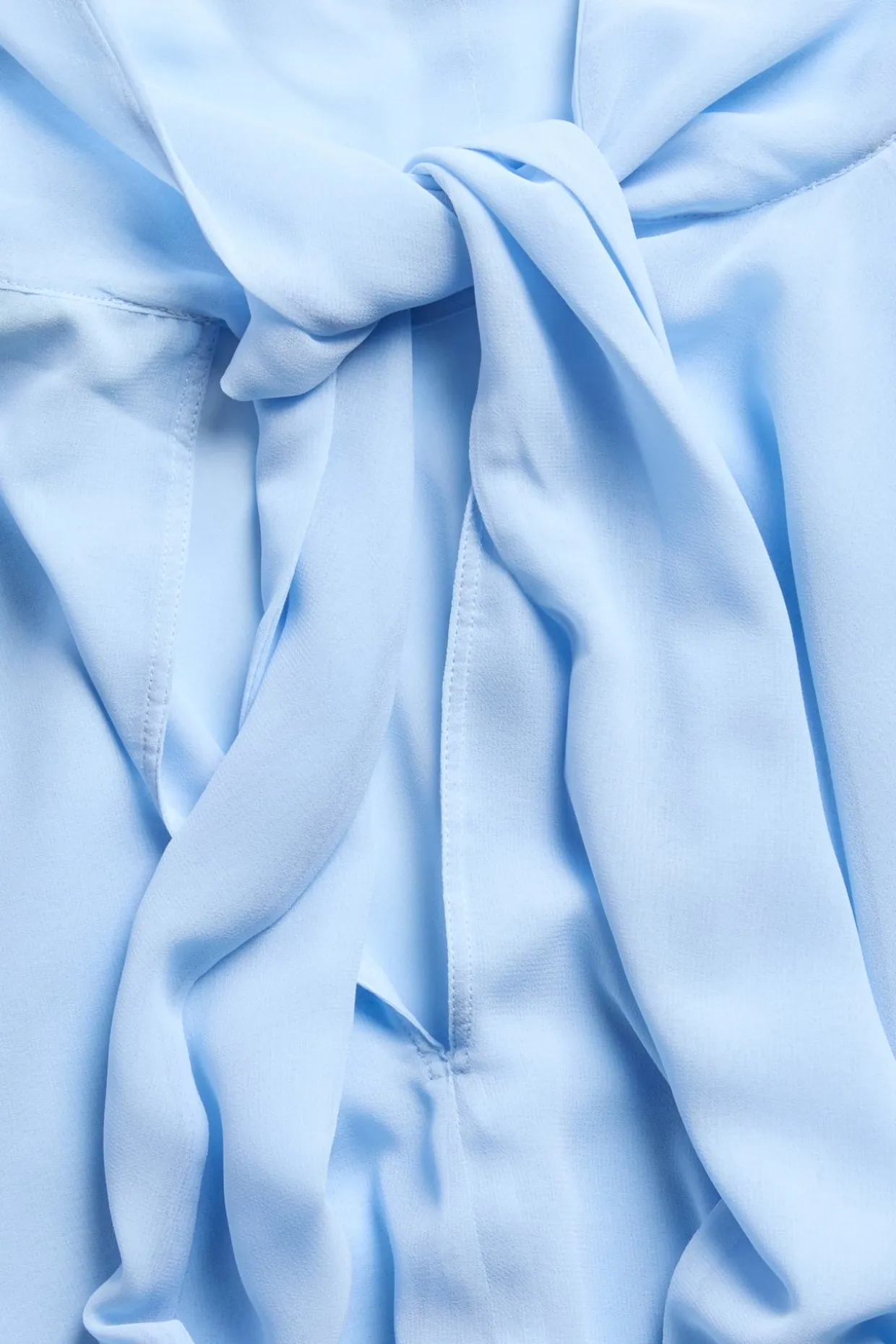 Chiffongblus med cape‑silhuett