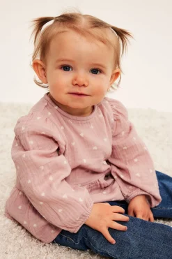 Peplumblus för baby i mjuk muslin